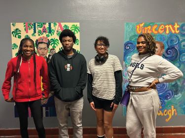  four students standning shoulder to shoulder